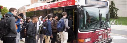 students getting on a bus