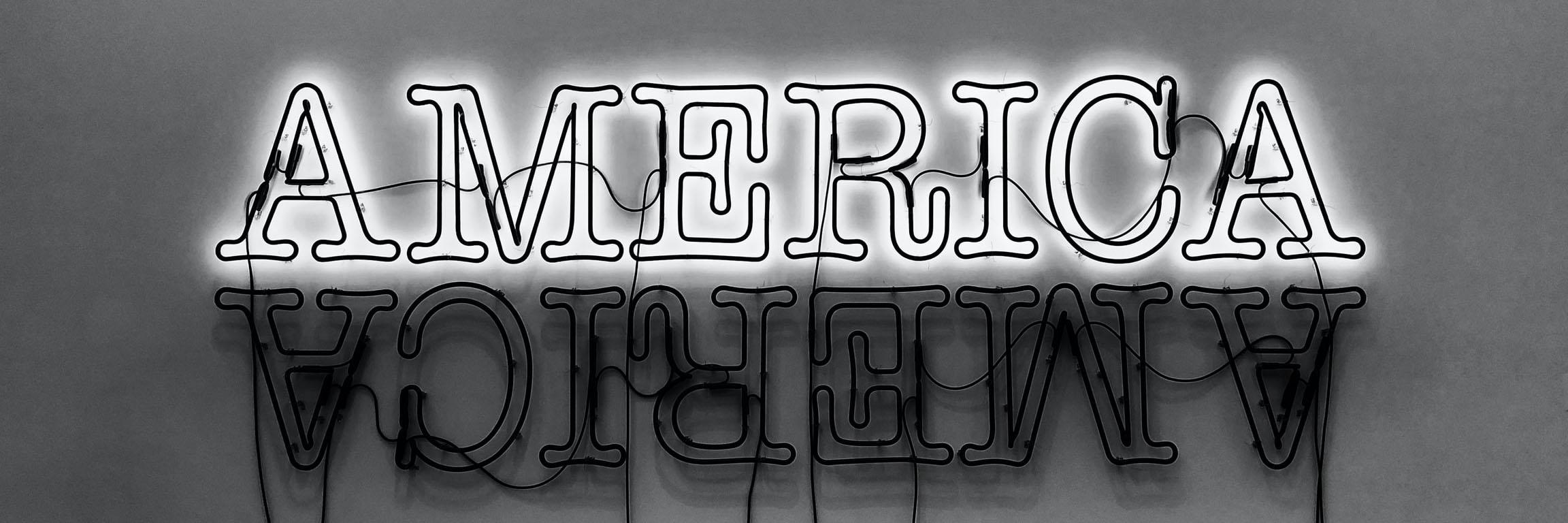 Black and white photo of a neon America sign